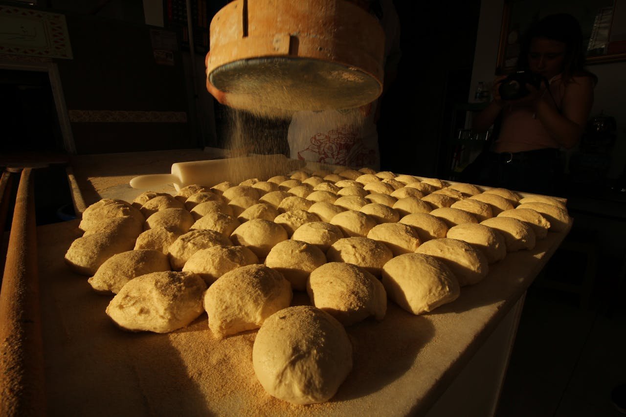 Artisan bread dough being prepared in a Turkish bakery, showcasing traditional baking techniques.
